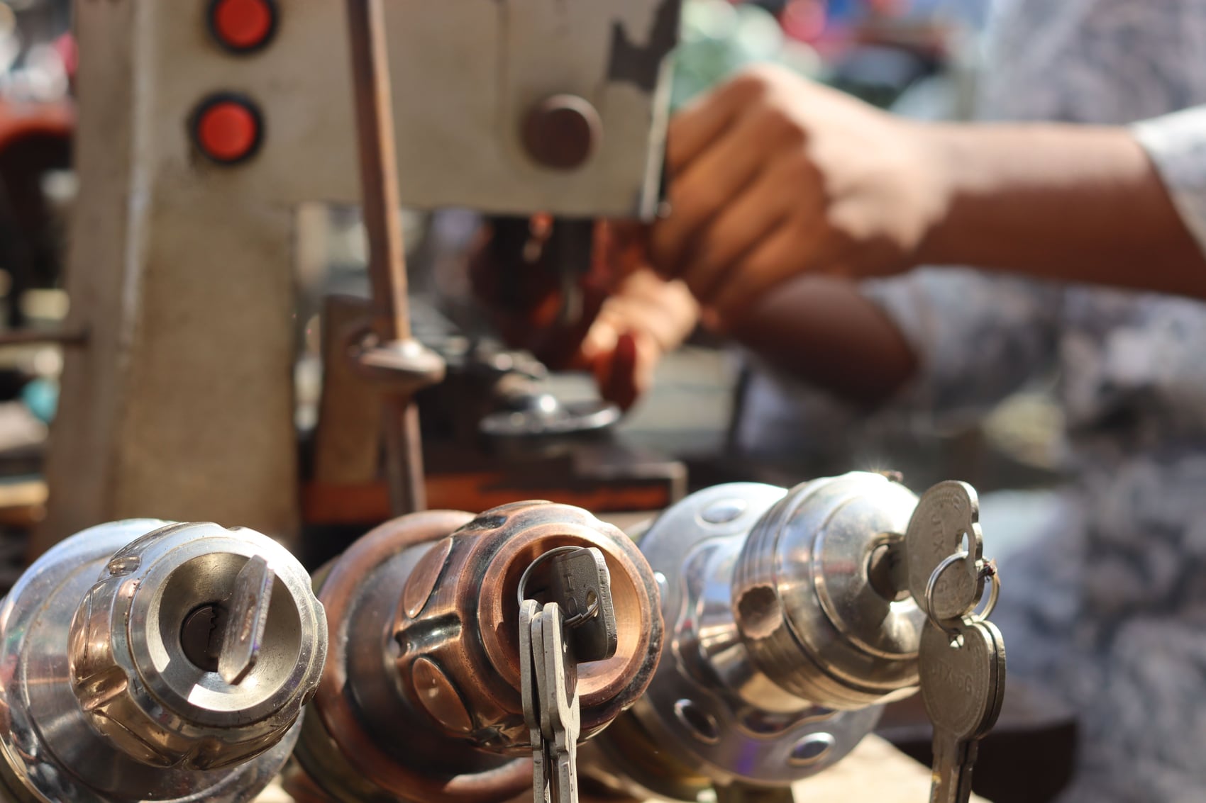 A locksmith precisely cutting a key on professional equipment